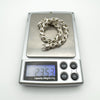Bracelet shown on digital scale weighing approximately 23.5 grams