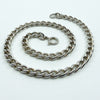 18 inch sterling silver curb chain laid out, bolt ring clasp visible.