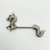 Close-up of silver dragon barbell with red gemstone eye on white background