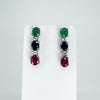 Front view of sterling silver drop earrings set with ruby, sapphire, emerald and white topaz