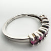 Detailed close-up of TGGC hallmark inside the ring band with garnets in partial view