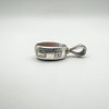 Close-up of lion passant and date letter on vintage reversible silver pendant