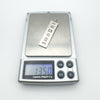 Pendant placed on digital scales displaying 13.50 grams