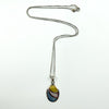 Sterling silver oval inlay pendant on fine box chain, multicolour mother of pearl style panels, white background.