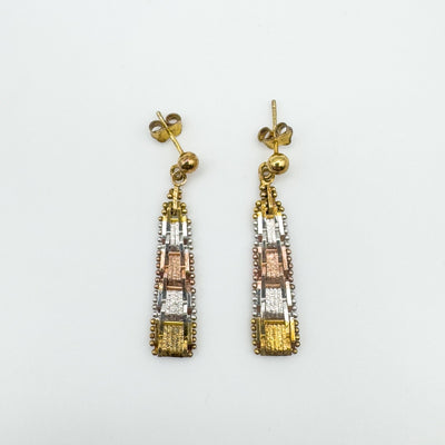 Flat lay of tricolour sterling silver earrings with plaited design