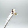 Side profile of gold amethyst studs displayed on white earring stand