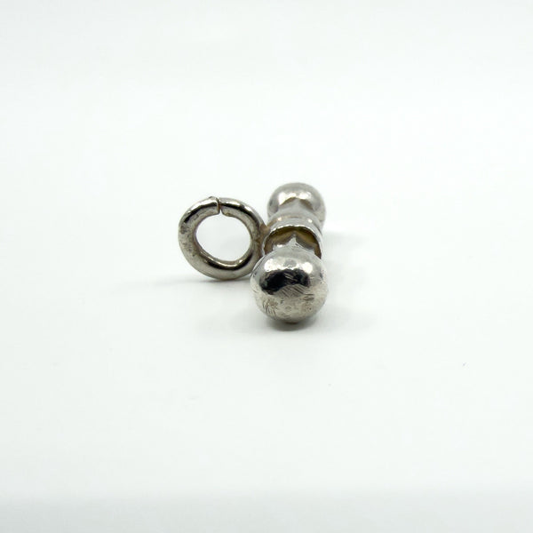 Polished sterling silver T-bar pendant with bail, showing the central band from the side.