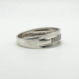 Tapered view of sterling silver ring with natural diamonds in flush setting