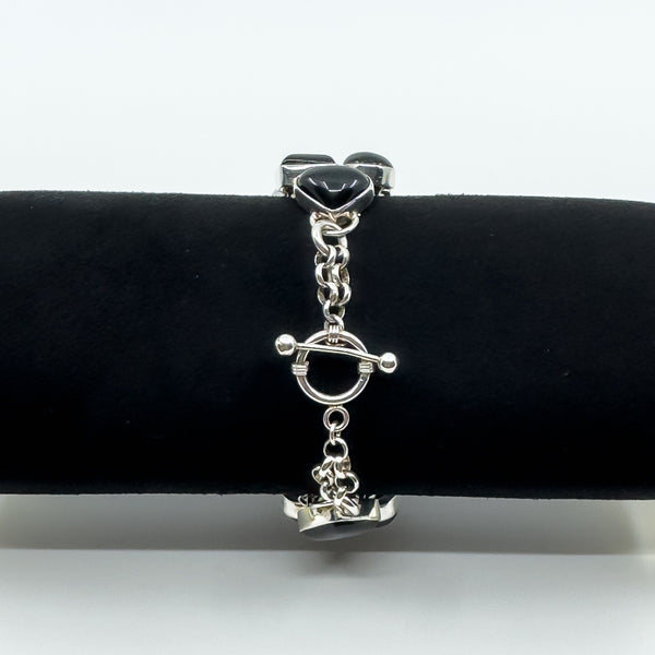 Sterling silver black onyx bracelet on display roll showing toggle clasp and chain detail