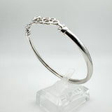 Overhead view highlighting the oval shape and slim silver band