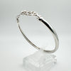 Overhead view highlighting the oval shape and slim silver band
