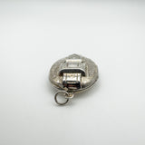 Close-up of locket top loop and raised buckle motif