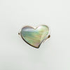 Overhead view of heart-shaped white mother of pearl in silver ring