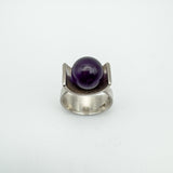 Top view of vintage sterling silver ring with central amethyst ball