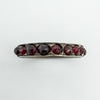 Close-up top view of vintage Bohemian garnet eternity ring in sterling silver