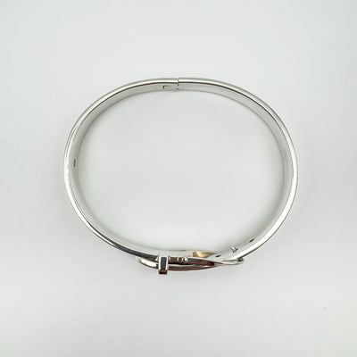 Oval-shaped sterling silver buckle bangle laid flat
