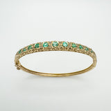 9ct gold bangle with natural emeralds and diamonds in claw setting