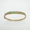 9ct gold bangle with natural emeralds and diamonds in claw setting