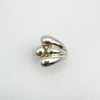 Overhead view of teardrop-shaped wrap over ring in sterling silver