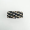 Top view showing diagonal rows of white and cognac diamonds in silver band