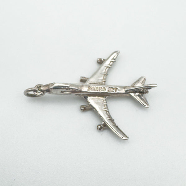 Flat-lay image showing the full outline and detail of the 747 silver pendant