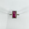 Top-down image of ruby and diamond ring in rectangular setting