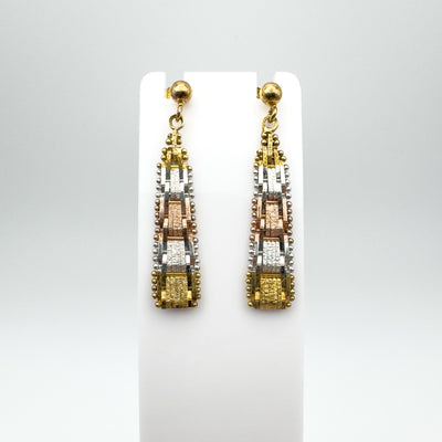 Close-up of drop earrings in sterling silver with rose and yellow gold plating