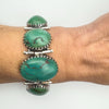 Sterling silver bracelet with green turquoise stones worn on wrist 1