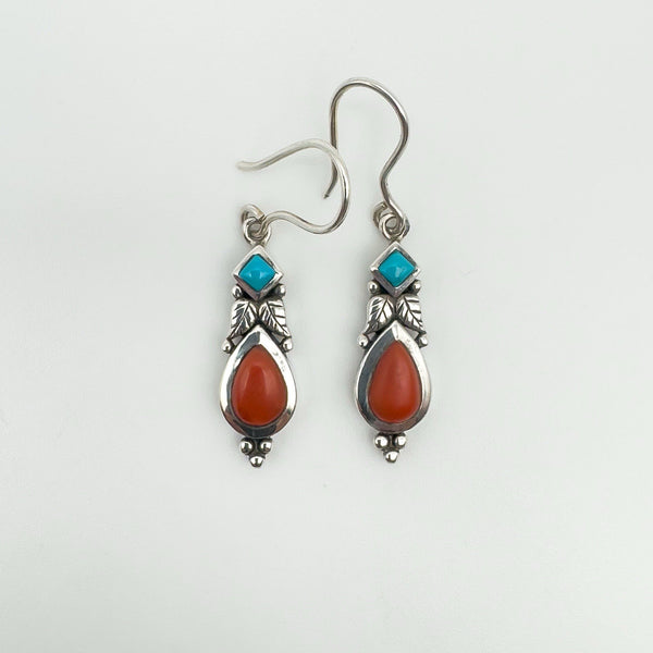 Dangly sterling silver earrings with turquoise and coral cabochons, front view