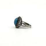 Side detail of the sterling silver turquoise ring with openwork halo setting