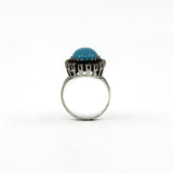 Side view of a sterling silver turquoise and rough cut diamond halo ring