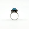 Side view of a sterling silver turquoise and rough cut diamond halo ring