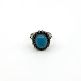 Upright view showing the high turquoise and diamond halo ring setting