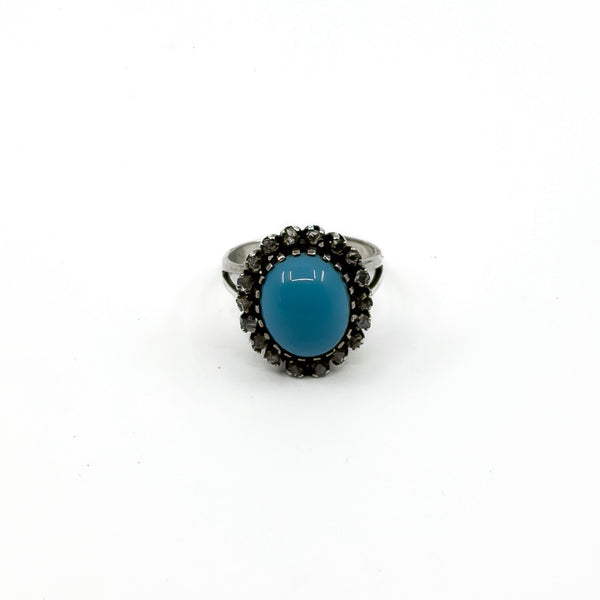 Upright view showing the high turquoise and diamond halo ring setting