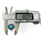 Calipers showing the turquoise diamond halo ring head measuring approximately 18mm