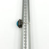 Side view of the sterling silver turquoise diamond halo ring on a UK ring mandrel