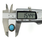 Calipers showing the turquoise and diamond halo ring head width measuring approximately 15.4mm