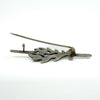 Back of vintage sterling silver turquoise brooch showing C hook clasp and pin fitting.
