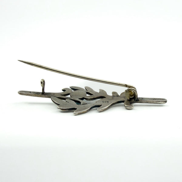 Back of vintage sterling silver turquoise brooch showing C hook clasp and pin fitting.