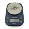 Vintage sterling silver turquoise brooch on digital scales showing approx. 2.88g weight.