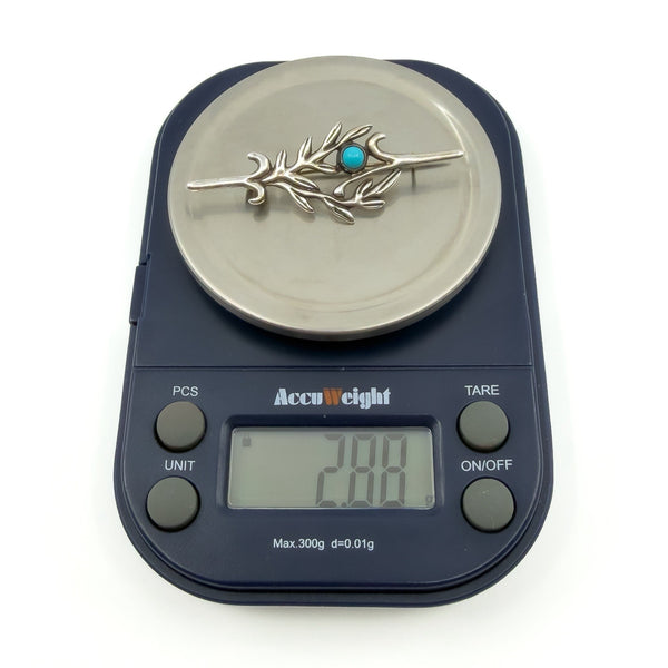 Vintage sterling silver turquoise brooch on digital scales showing approx. 2.88g weight.