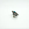 Side view of the sterling silver turquoise brooch showing the cabochon setting height and pin fitting.