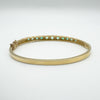 Back view of gemstone settings on vintage gold emerald bangle