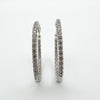 Close up showing CZ sparkle on sterling silver hoop earrings