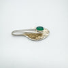 Hammered silver spoon pendant with green chrysoprase laying flat