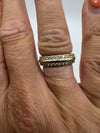 Gold plated sterling silver CZ band ring worn on finger for scale