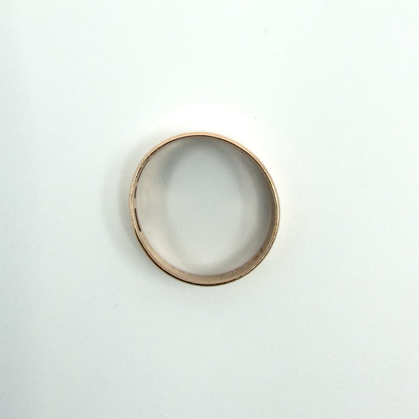Interior view of a Victorian 9ct rose gold band ring with visible maker and purity marks.