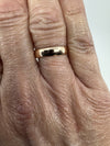 Victorian 9ct rose gold band ring shown worn on the hand for scale.
