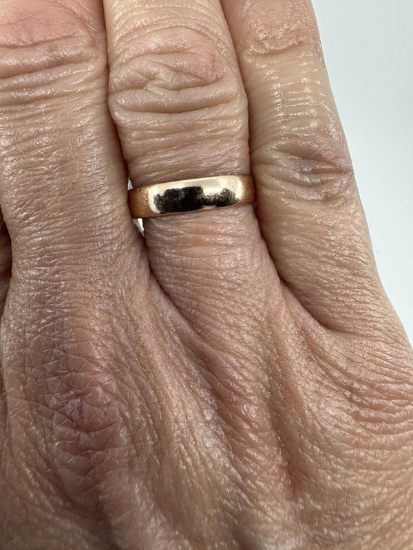 Victorian 9ct rose gold band ring shown worn on the hand for scale.
