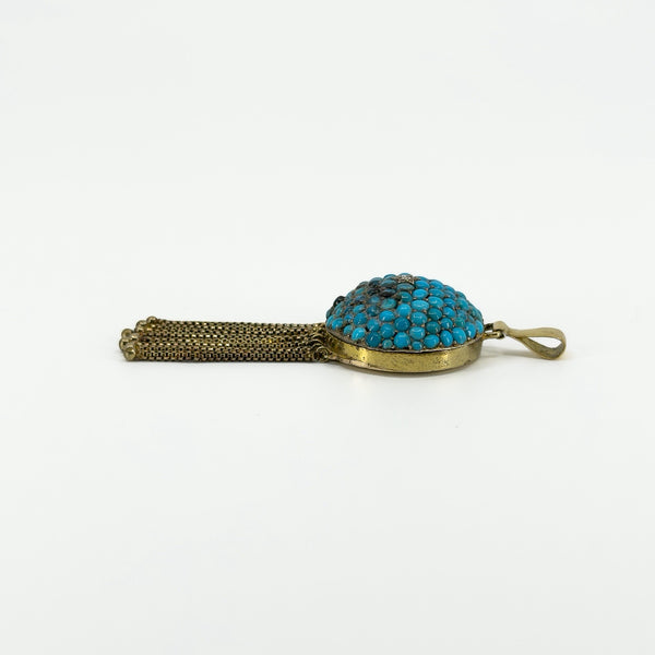Side profile of Victorian 18ct gold turquoise and diamond locket showing the domed setting, tassels and bail.